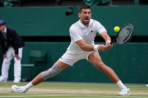 Novak Djokovic plays a backhand return to Lorenzo Musetti